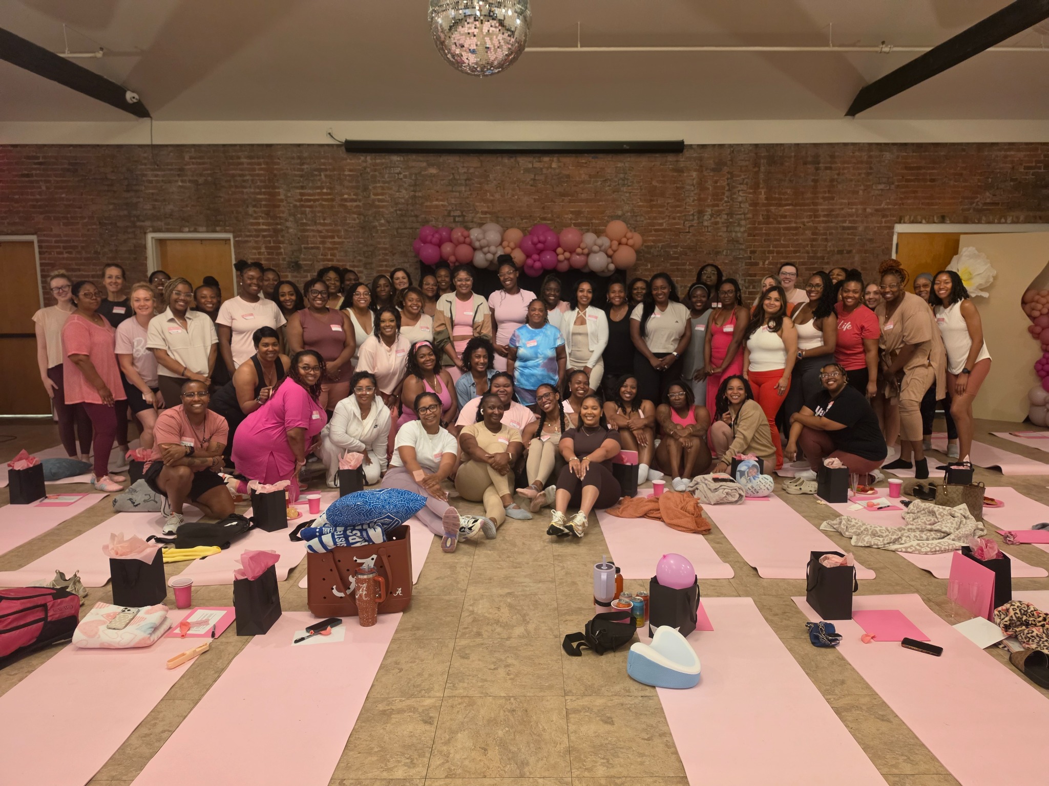 A large group of women gathered at the Aire and Ease annual wellness experience